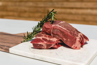 two steaks and some rosemary ready for the bbq