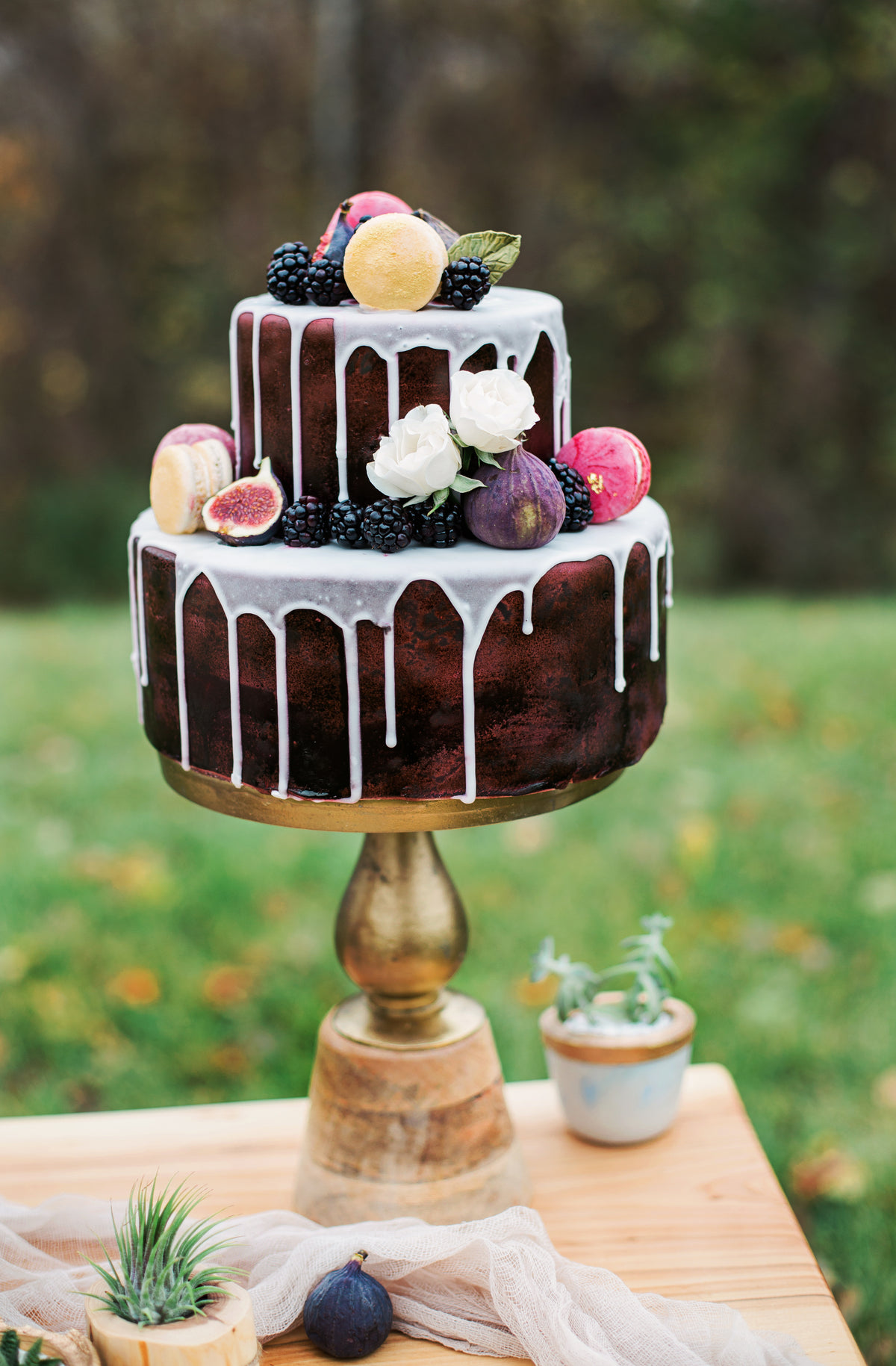 two tier cake decorated with flowers and fruit