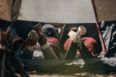 two women hanging out in a tent