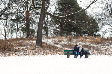 two women keep warm on a winter day in the park