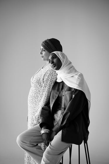 two women pose in black and white