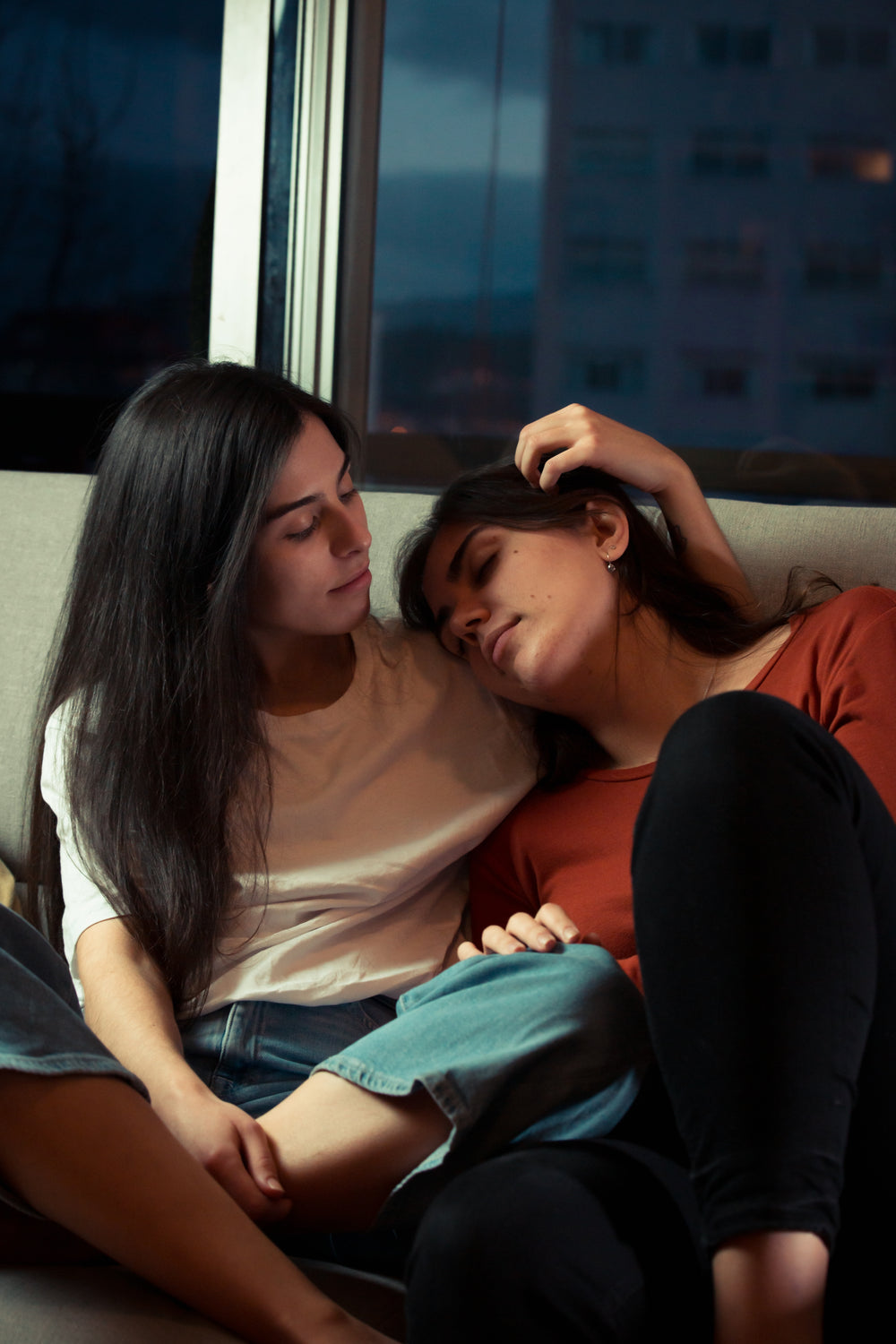 two women share a quiet moment together at home