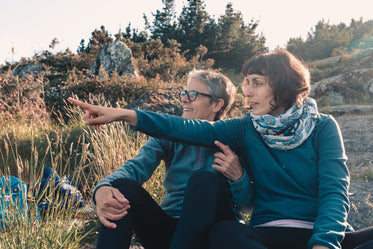 two women sit together enjoying the outdoors