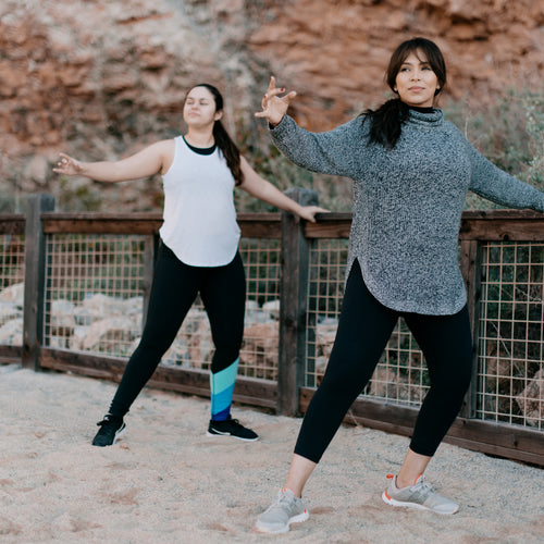 Two Women Stretching On The Beach