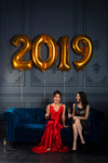 two women toast to 2019 with champagne