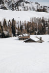 two wooden cabins in snow
