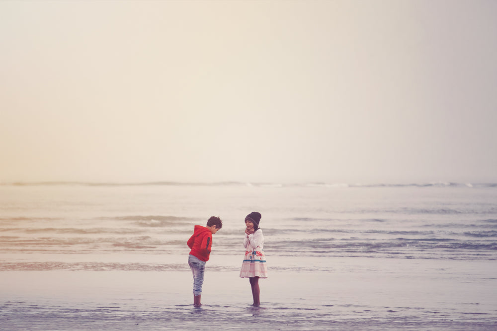 two young people share a happy moment on a beach