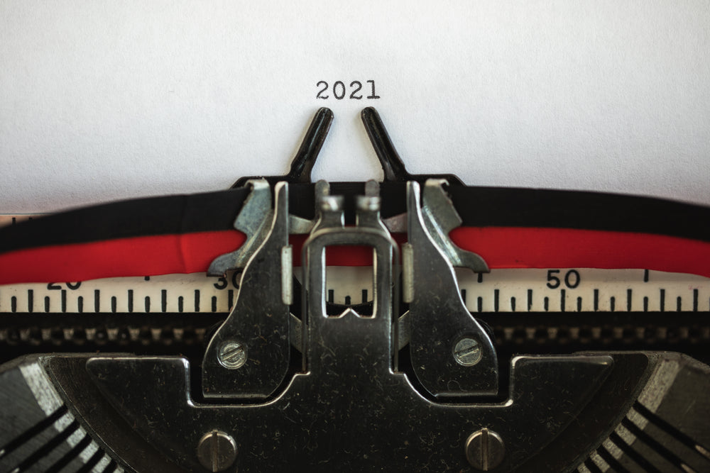 typewriter holds papers with the numbers 2021