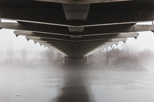 under bridge on foggy waters