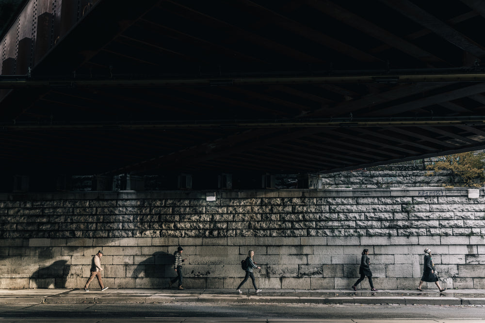 under busy city bridge people walking