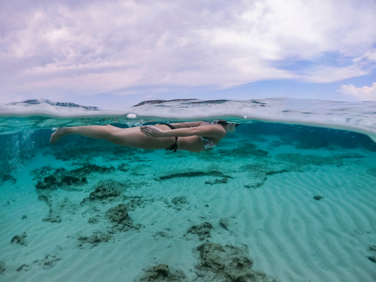 underwater photo of a person swimming in the sea