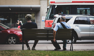 urban park bench by busy street