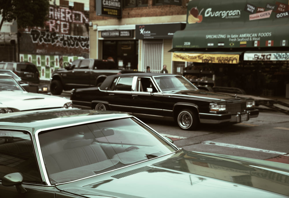 urban photo of cars driving through a cityscape