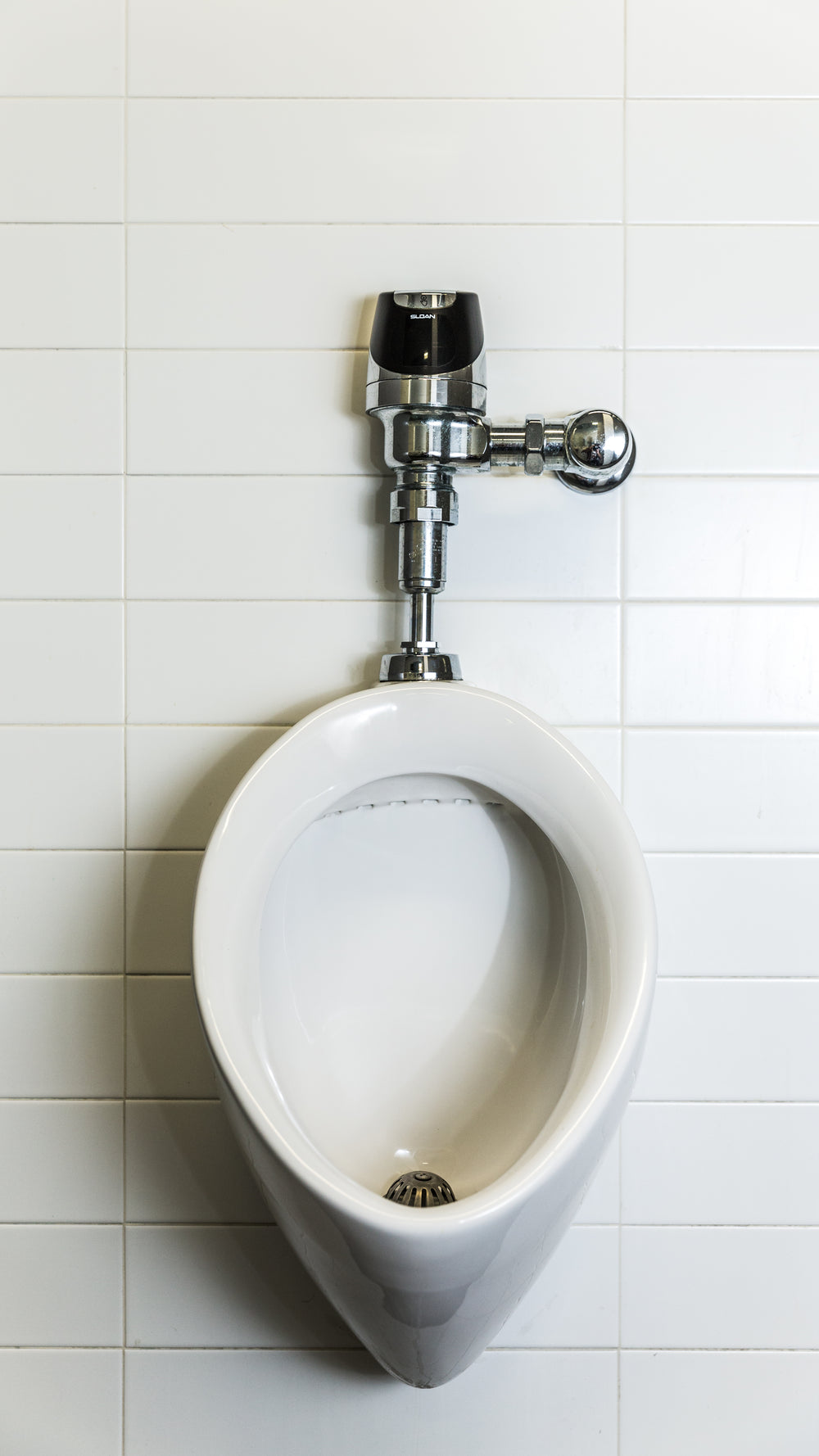 urinal on white tile phone background