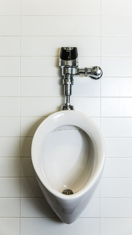 urinal on white tile phone background