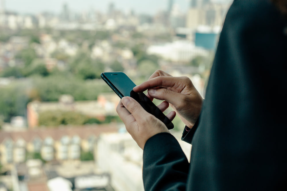 using smartphone with city in the background