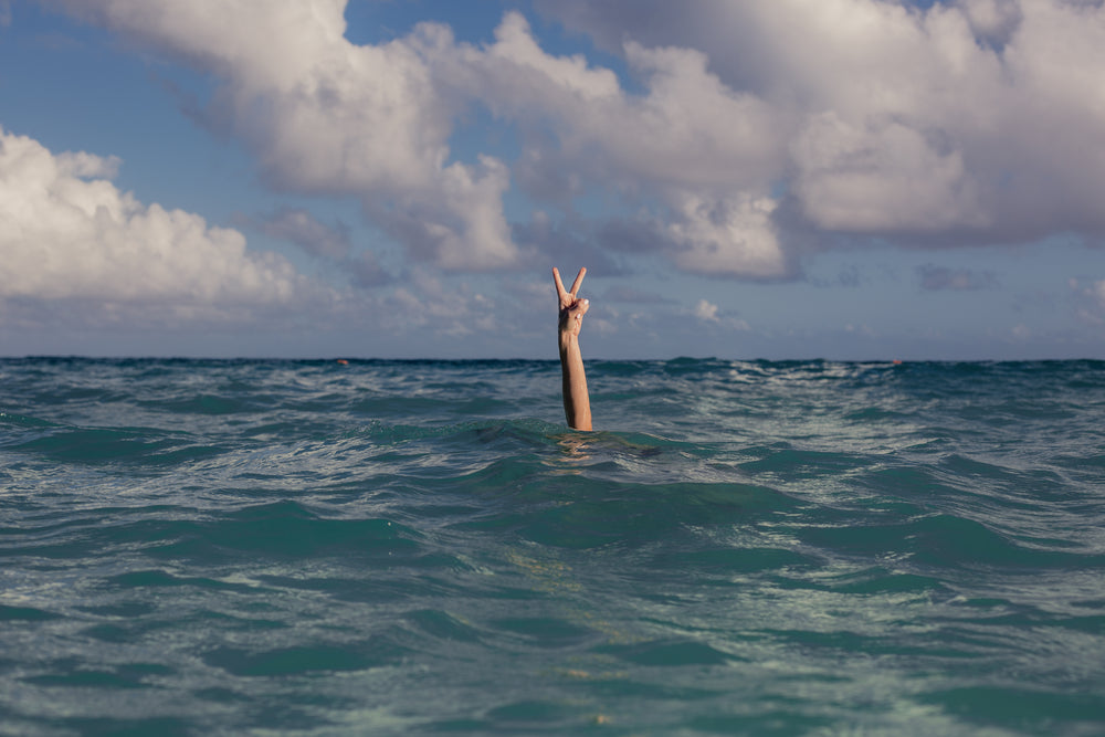 vacation peace sign in ocean