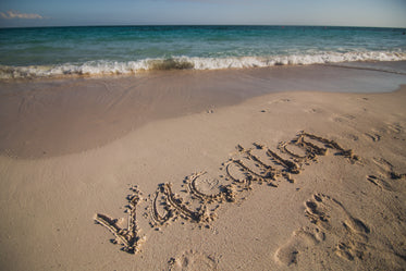 vacation written on beach