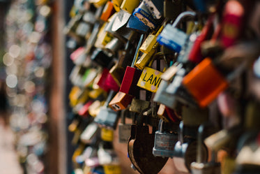 varied colorful locks on a fence