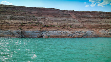 vibrant aqua blue water below cliff edge