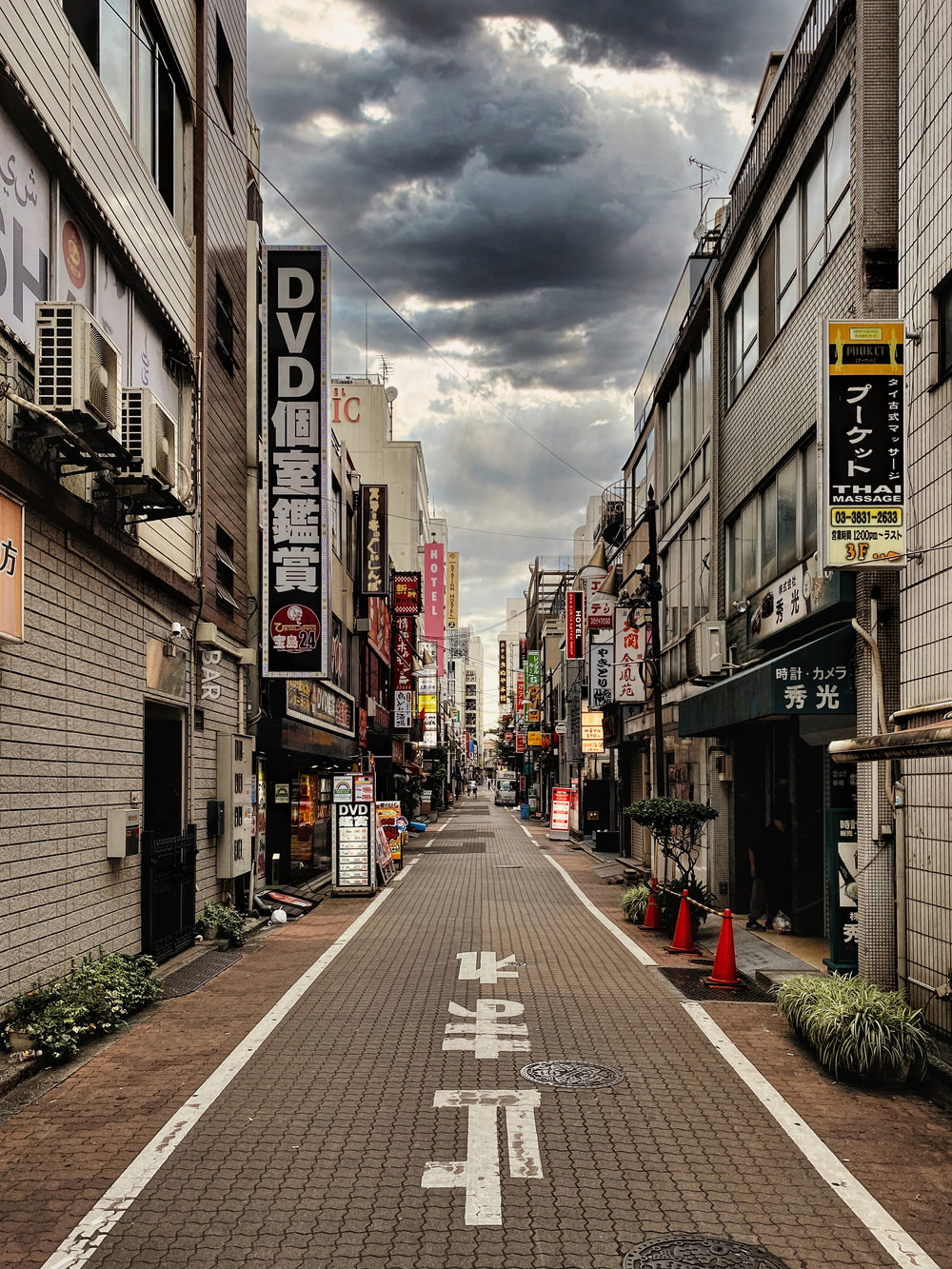 view down a city street with storm clouds overhead