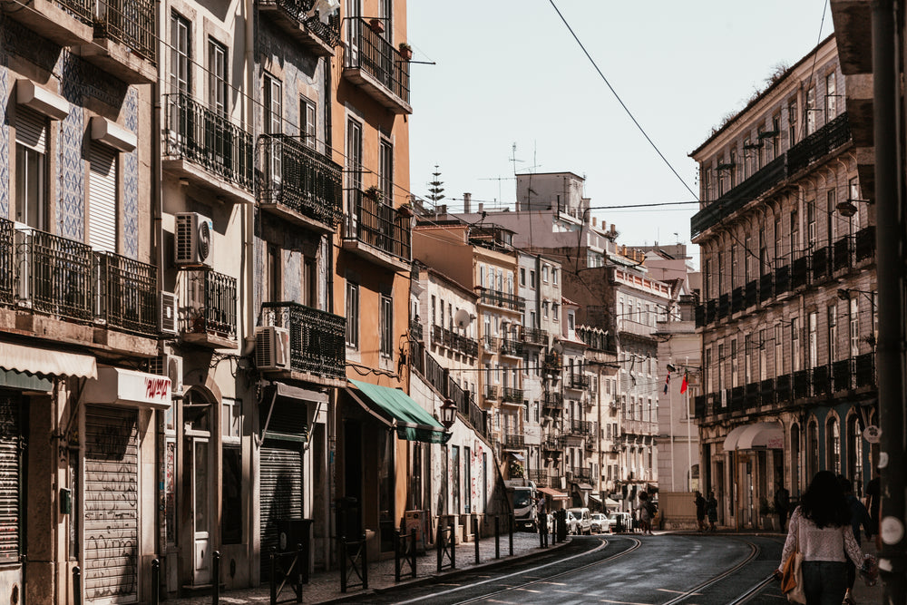 view down curved city street between buildings