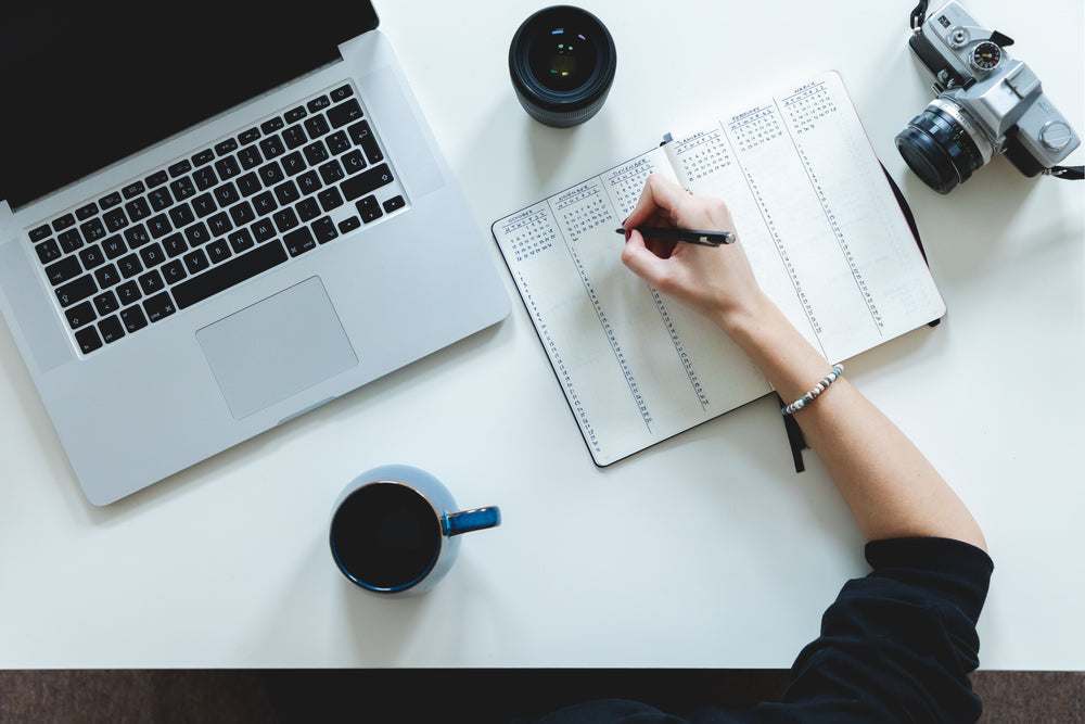 view from above as person sits at white desktop