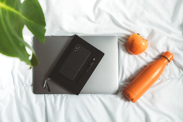 view from above of office items on a white duvet