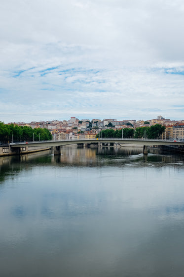 view of a town and modern bridge from still water