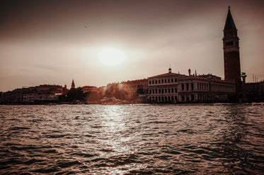 view of buildings on shore below a sunset