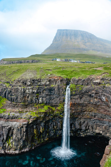 view of mulafossur waterfall from opposite cliffside