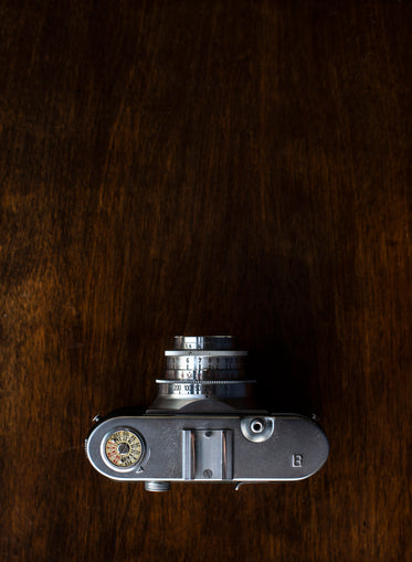 vintage camera on wooden table viewed from overhead