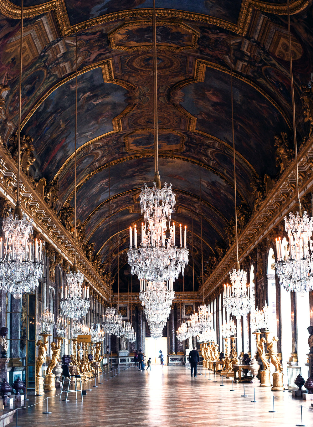 visitors walking through the hall of mirrors