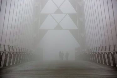 walkers on foggy bridge