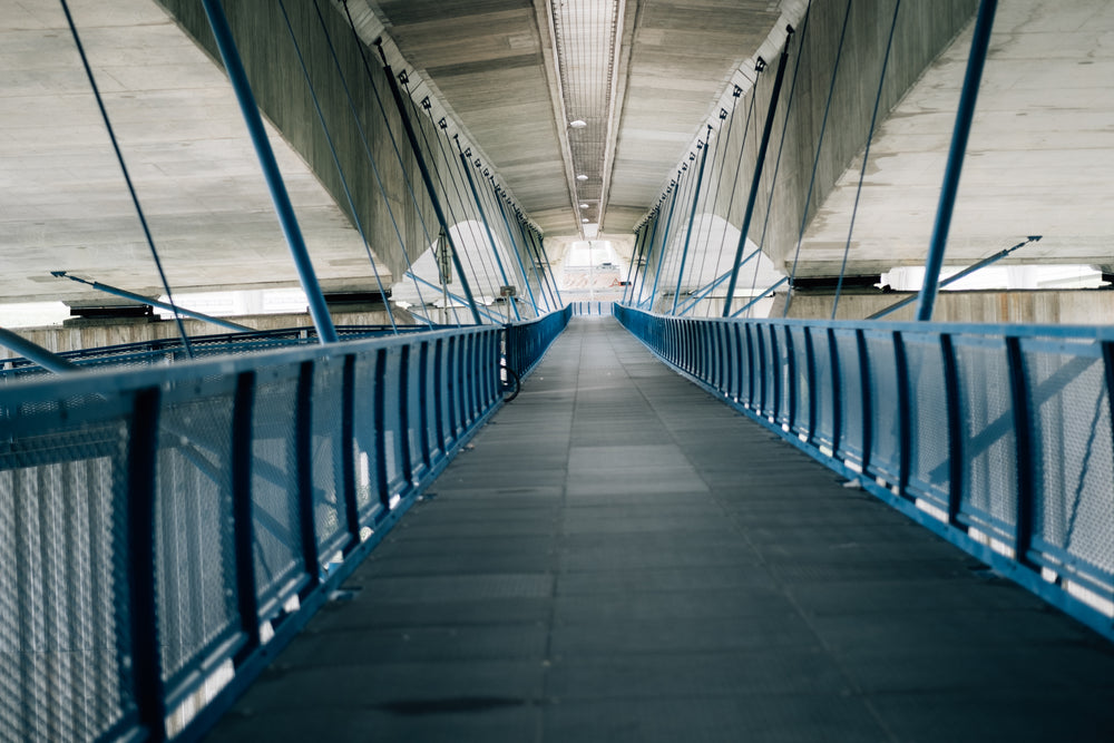 walkway with a cement ceiling above