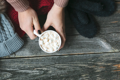 warming hands on hot cocoa