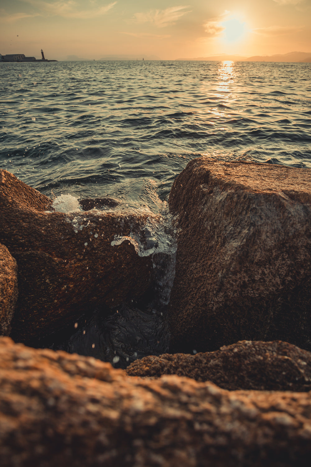 water breaks over rocky shoreline