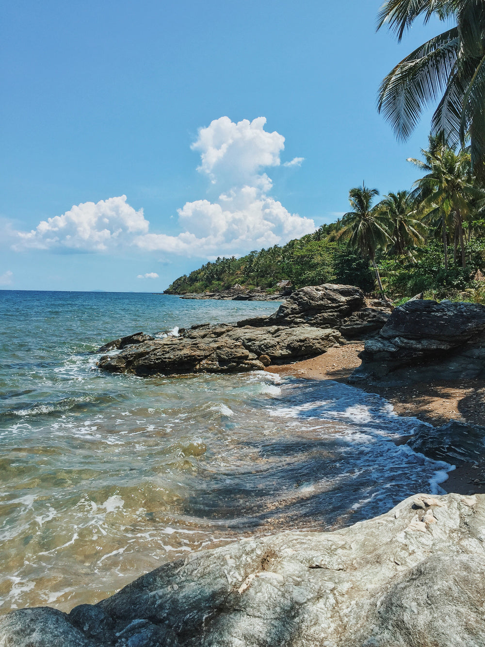 water crashes at rocky island shore