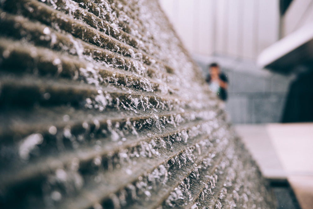 water falls over ridged surface