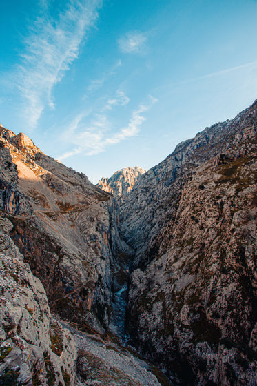 water flows through a narrow valley in mountains