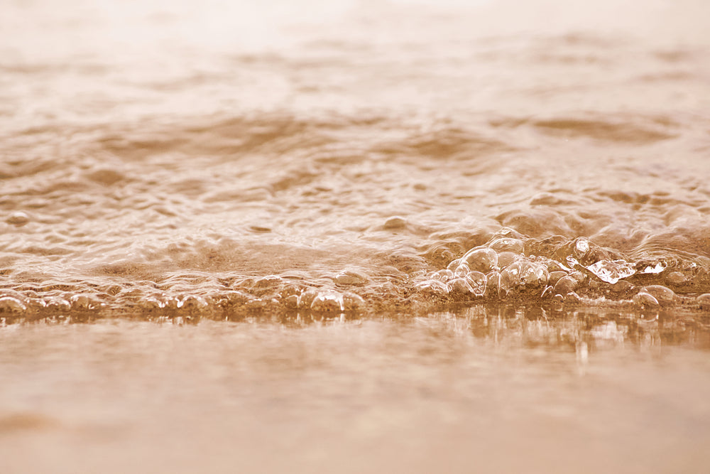 water gently bubbling onto beach