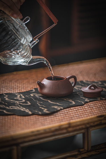 water poured from one teapot to another