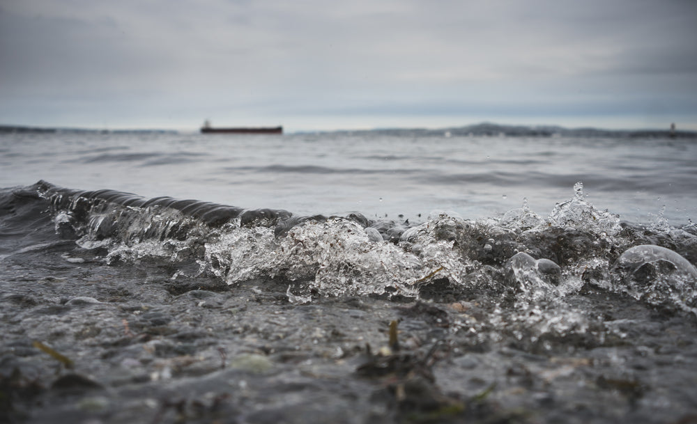 water rolls to shore on a cloudy day