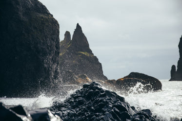 water splashing on black rock