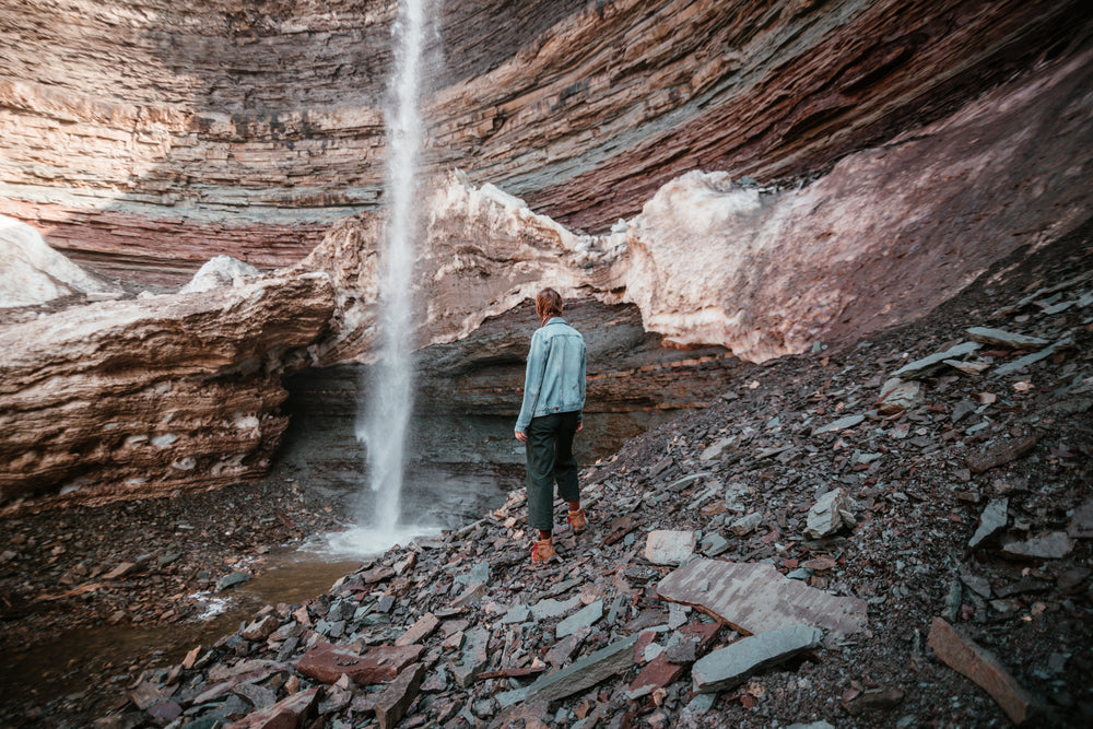 waterfall crashes at the bottom of a rockface