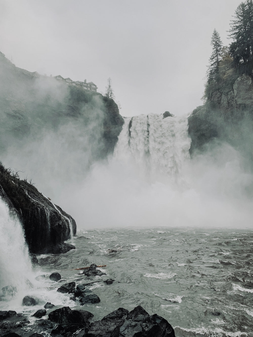 waterfall creating mist over the shore