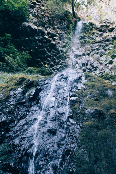 waterfall over rocky cliff's edge