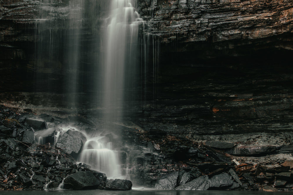 waterfall rains down to the rocks below