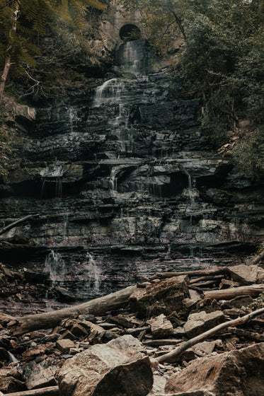 waterfall spills over jagged rock face