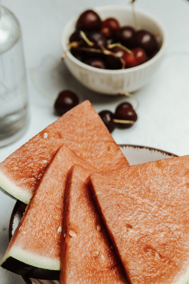 watermelon slices fanned out on a white plate